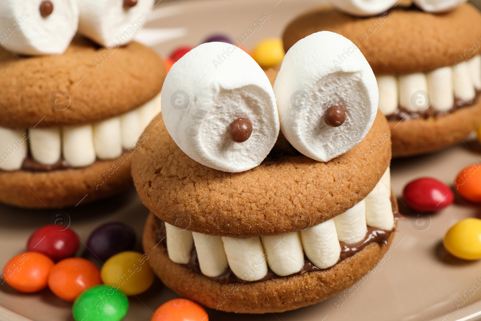 Photo of Delicious Halloween themed desserts on plate, closeup