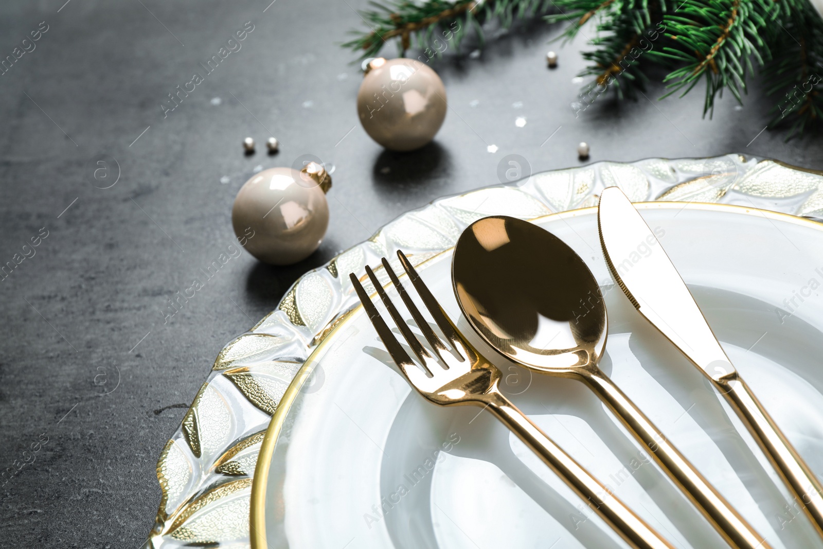 Photo of Christmas table setting on grey background, closeup