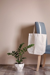 Photo of Eco tote bag in room interior. Space for design