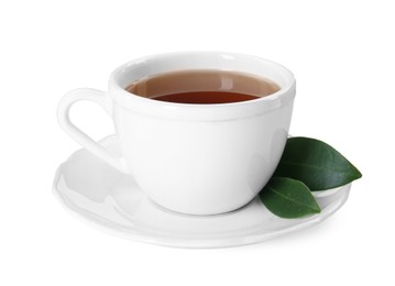Photo of Aromatic tea in cup and green leaves isolated on white