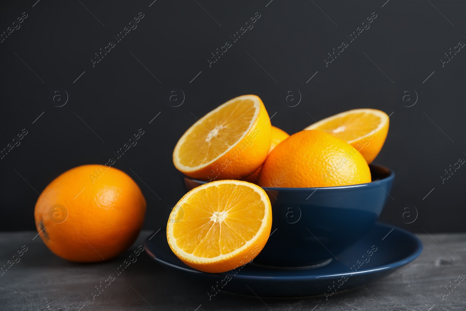 Photo of Fresh oranges in bowl on table. Healthy fruits