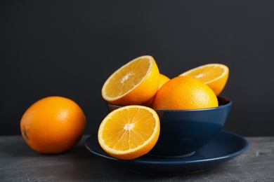 Fresh oranges in bowl on table. Healthy fruits