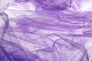 Photo of Beautiful purple tulle fabric as background, top view