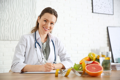 Photo of Female nutritionist working at desk in office