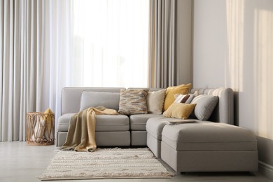 Photo of Living room interior with large grey sofa
