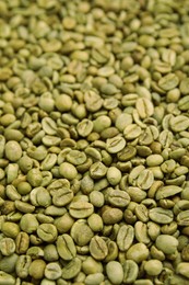 Pile of green coffee beans as background, closeup