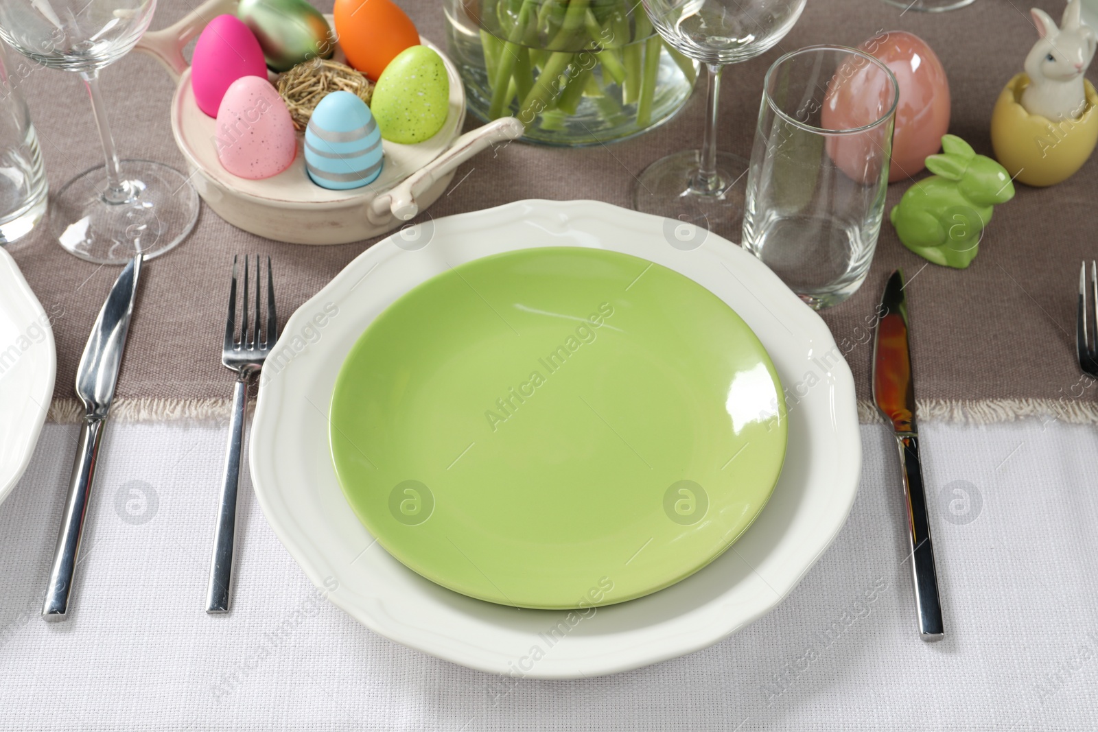 Photo of Easter celebration. Festive table setting with painted eggs