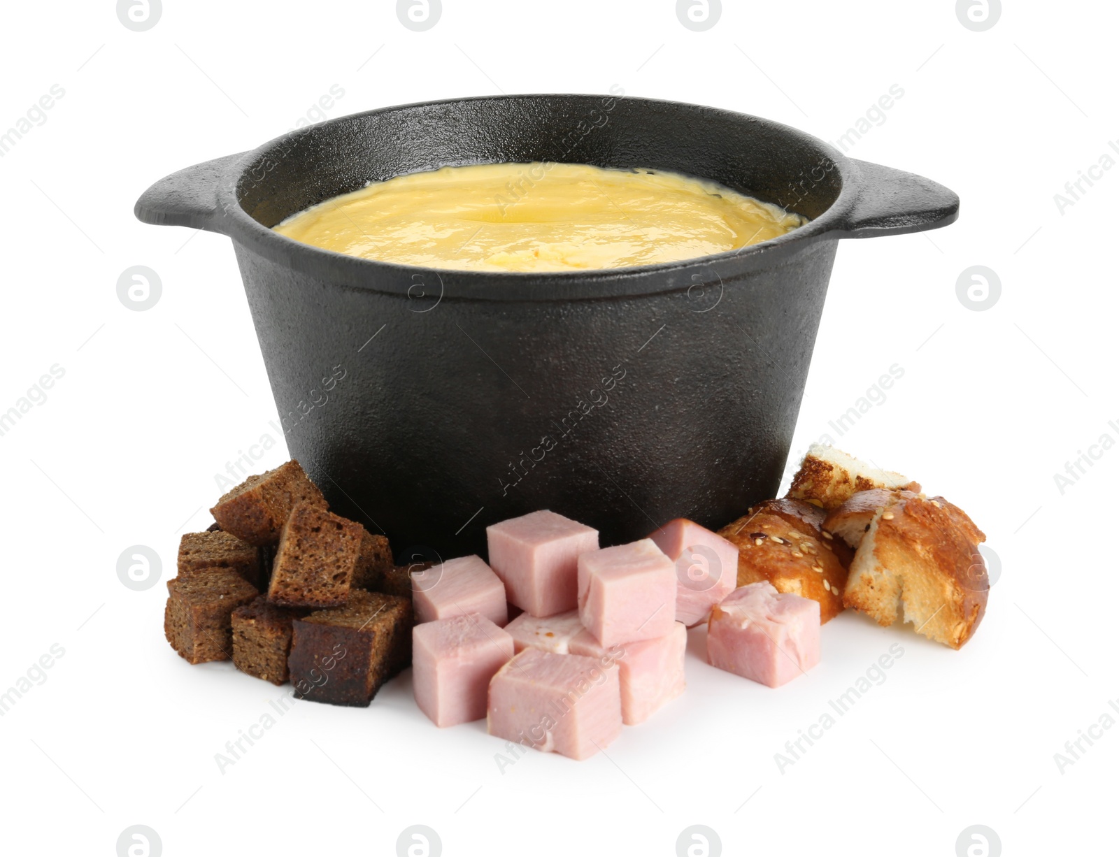 Photo of Fondue with tasty melted cheese, pieces of bread and ham isolated on white