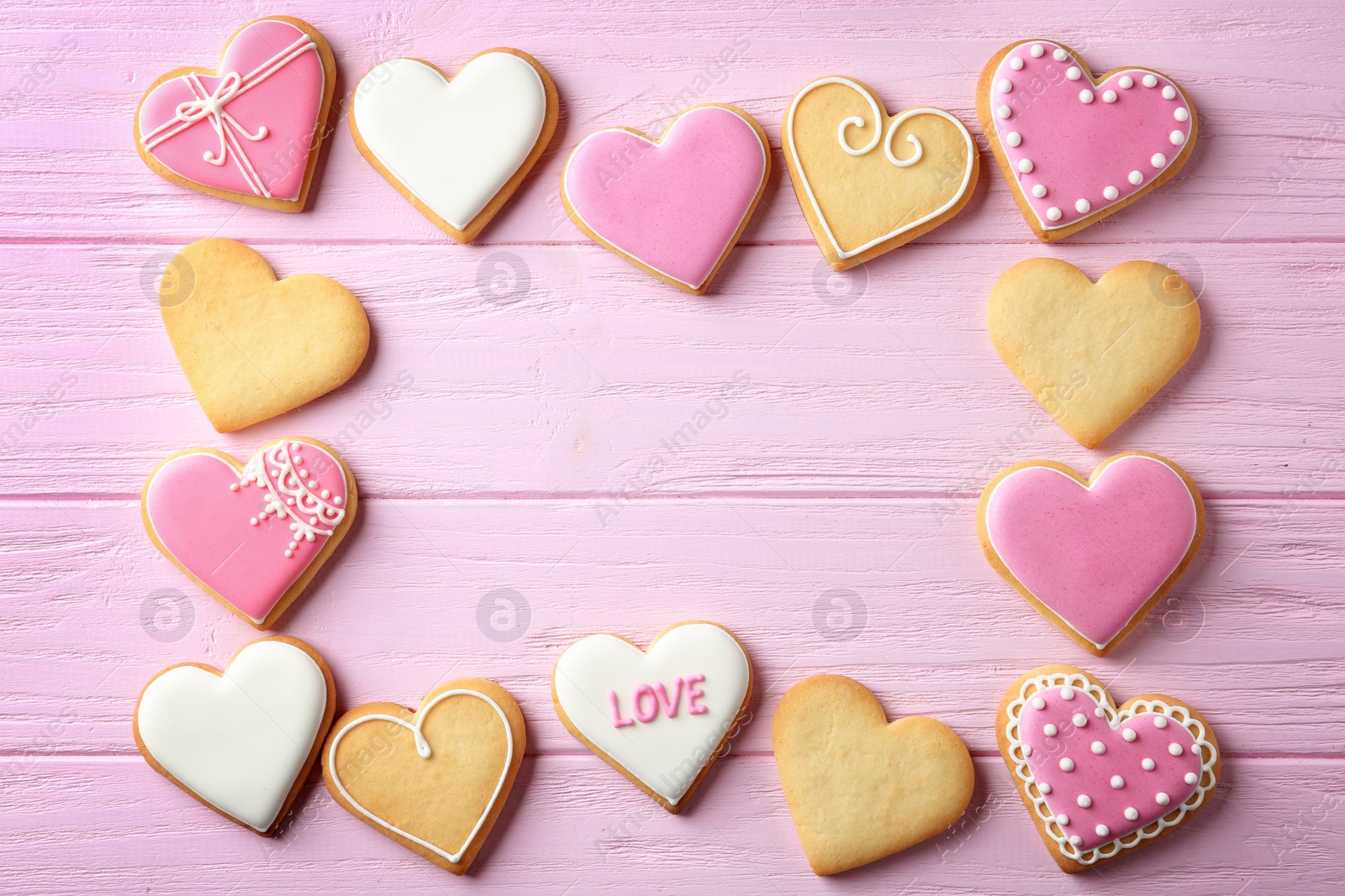 Photo of Flat lay composition with heart shaped cookies and space for text on wooden background. Valentine's day treat