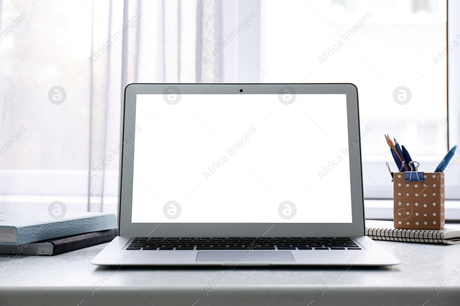 Image of Modern computer with blank screen on table at workplace. Space for design