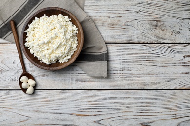 Photo of Cottage cheese and mozzarella on wooden background