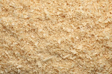 Photo of Dry natural sawdust as background, top view