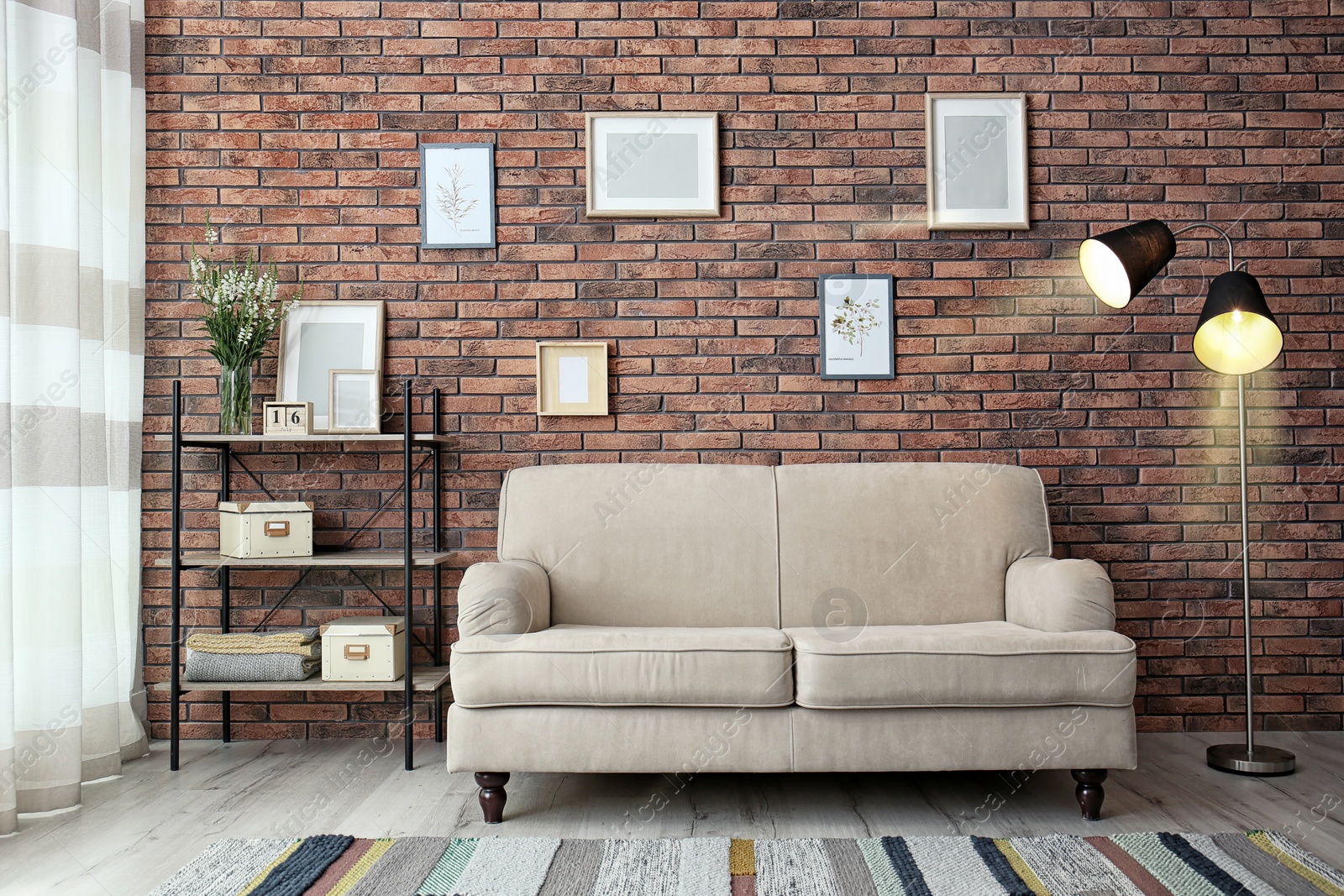 Photo of Modern living room interior with comfortable sofa near brick wall