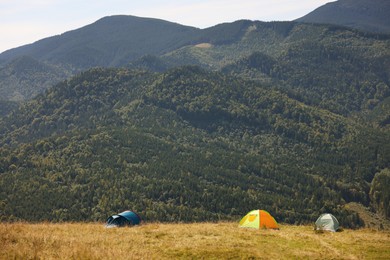Camping tents in mountains on sunny day