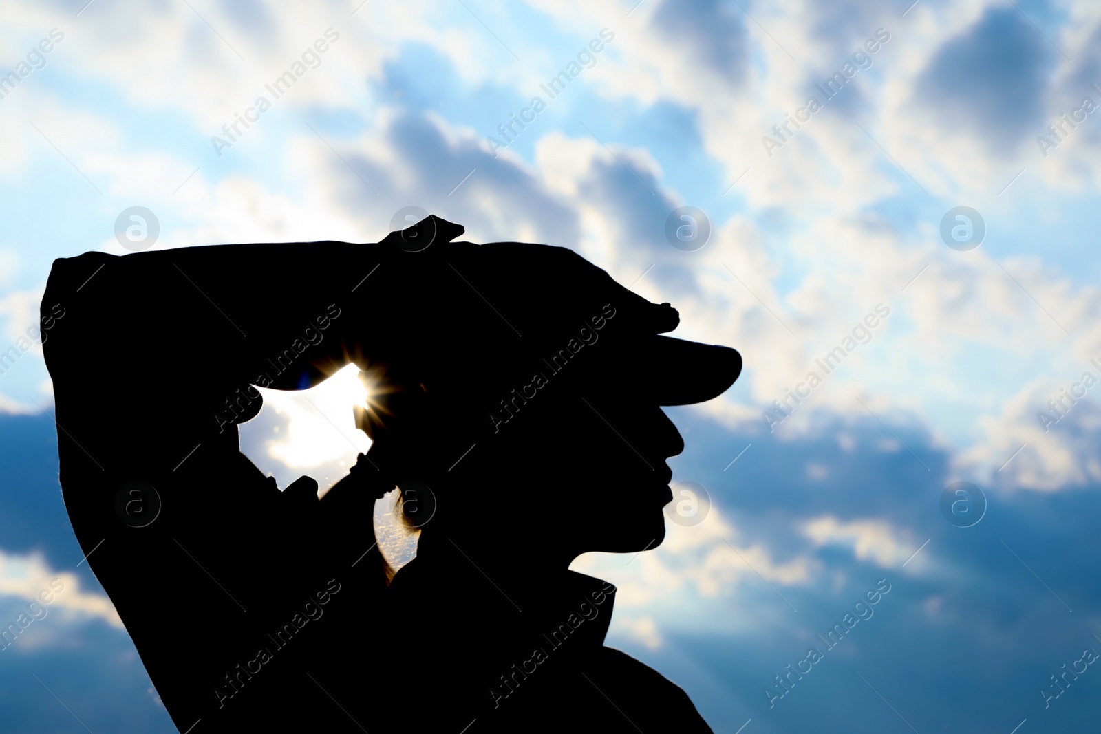 Photo of Female soldier in uniform saluting outdoors. Military service