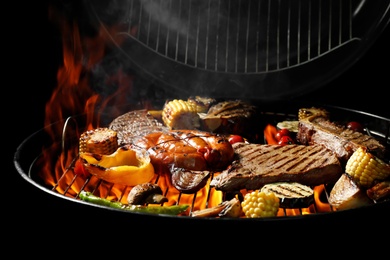 Assorted delicious meat and vegetables on barbecue grill