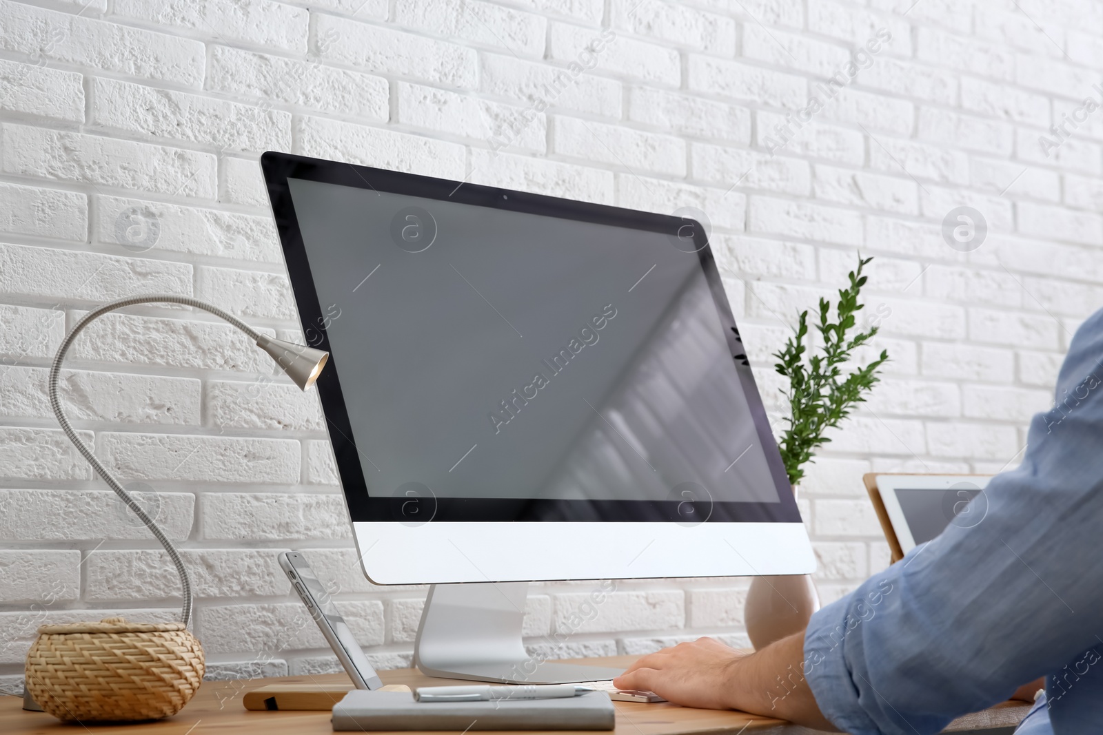 Photo of Young man using modern computer at table, closeup