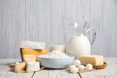 Photo of Different delicious dairy products on white wooden table