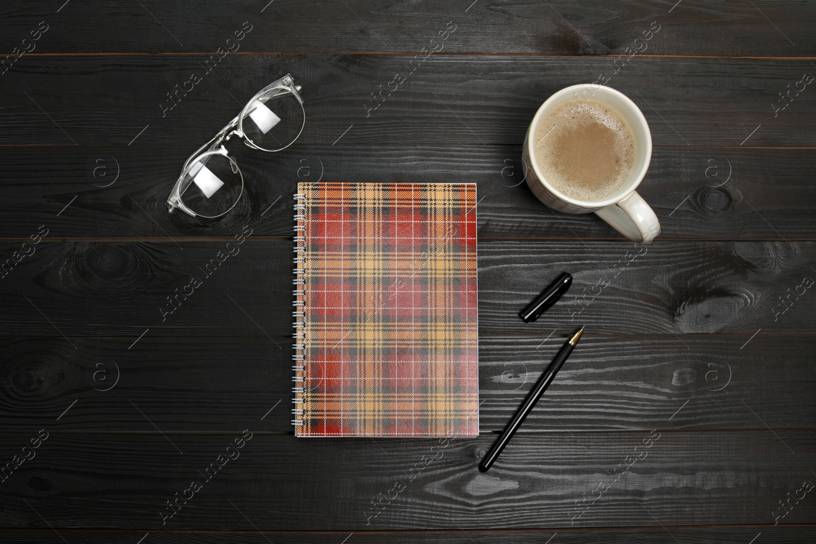 Photo of Flat lay composition with office stationery and cup of coffee on wooden table