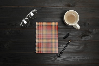 Photo of Flat lay composition with office stationery and cup of coffee on wooden table