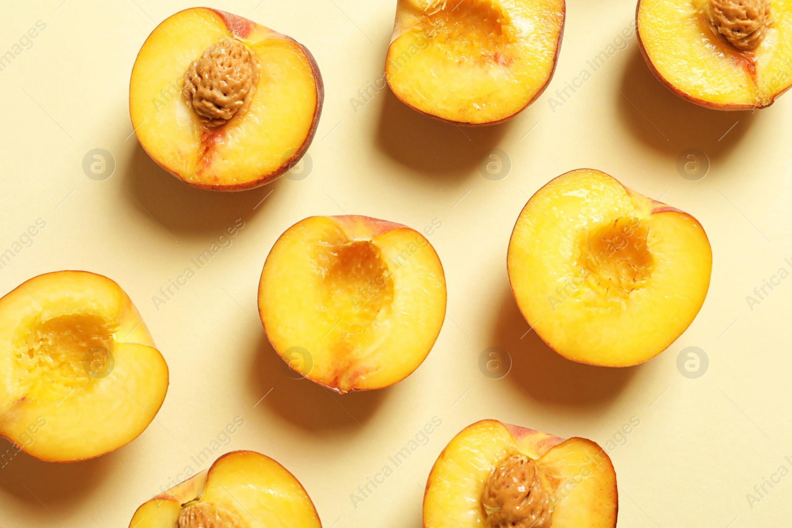 Photo of Flat lay composition with ripe peaches on color background