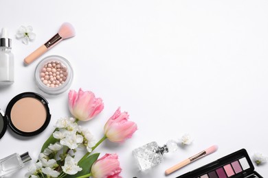 Photo of Flat lay composition with different makeup products and beautiful spring flowers on white background, space for text