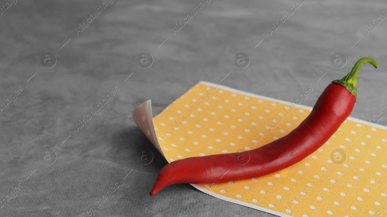 Photo of Pepper plaster and chili on grey textured background, closeup. Space for text