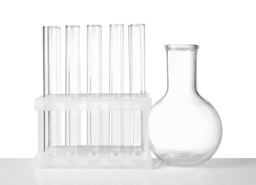 Photo of Empty laboratory flask and test tubes isolated on white