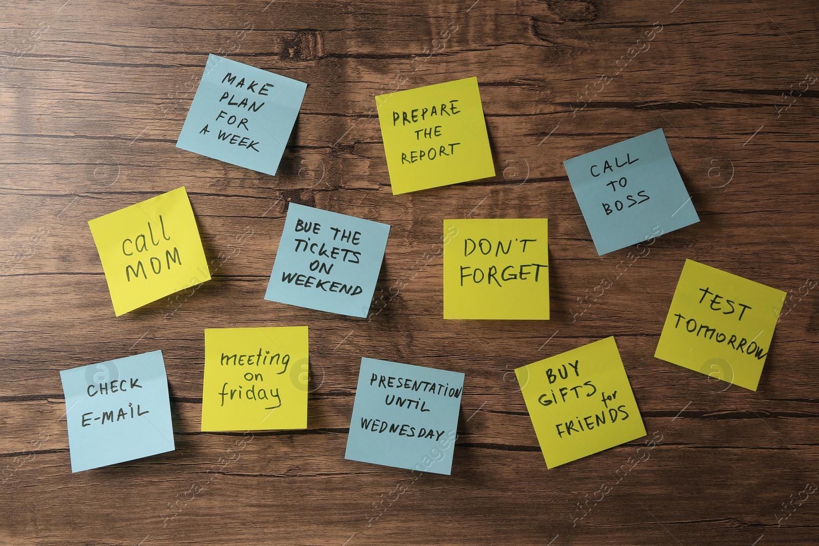 Photo of Paper notes with life-affirming phrases on wooden table, flat lay