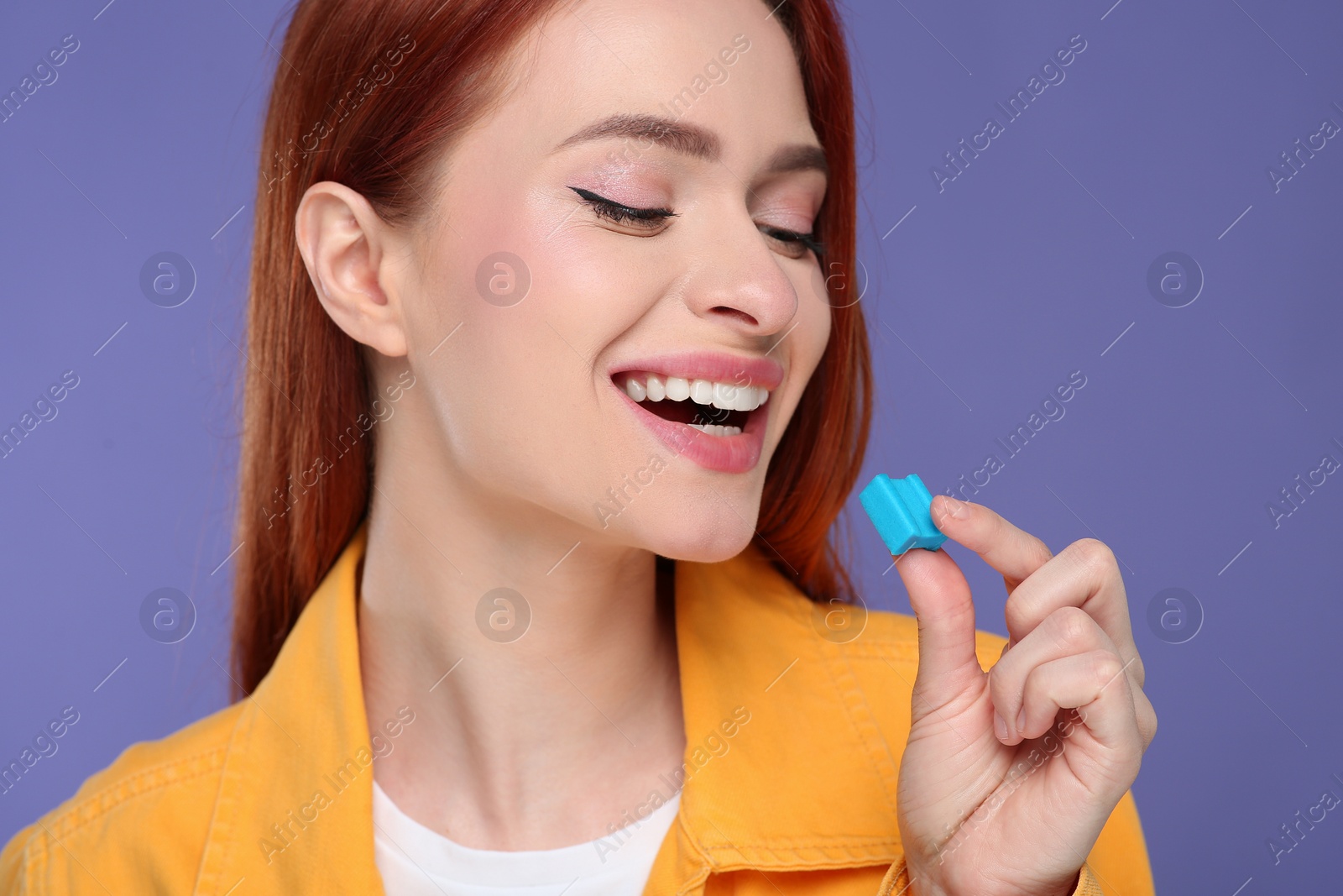 Photo of Beautiful woman with bubble gum on purple background