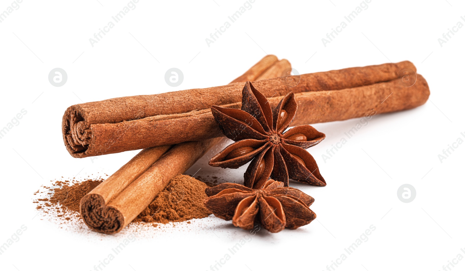 Photo of Dry aromatic cinnamon sticks, powder and anise stars isolated on white