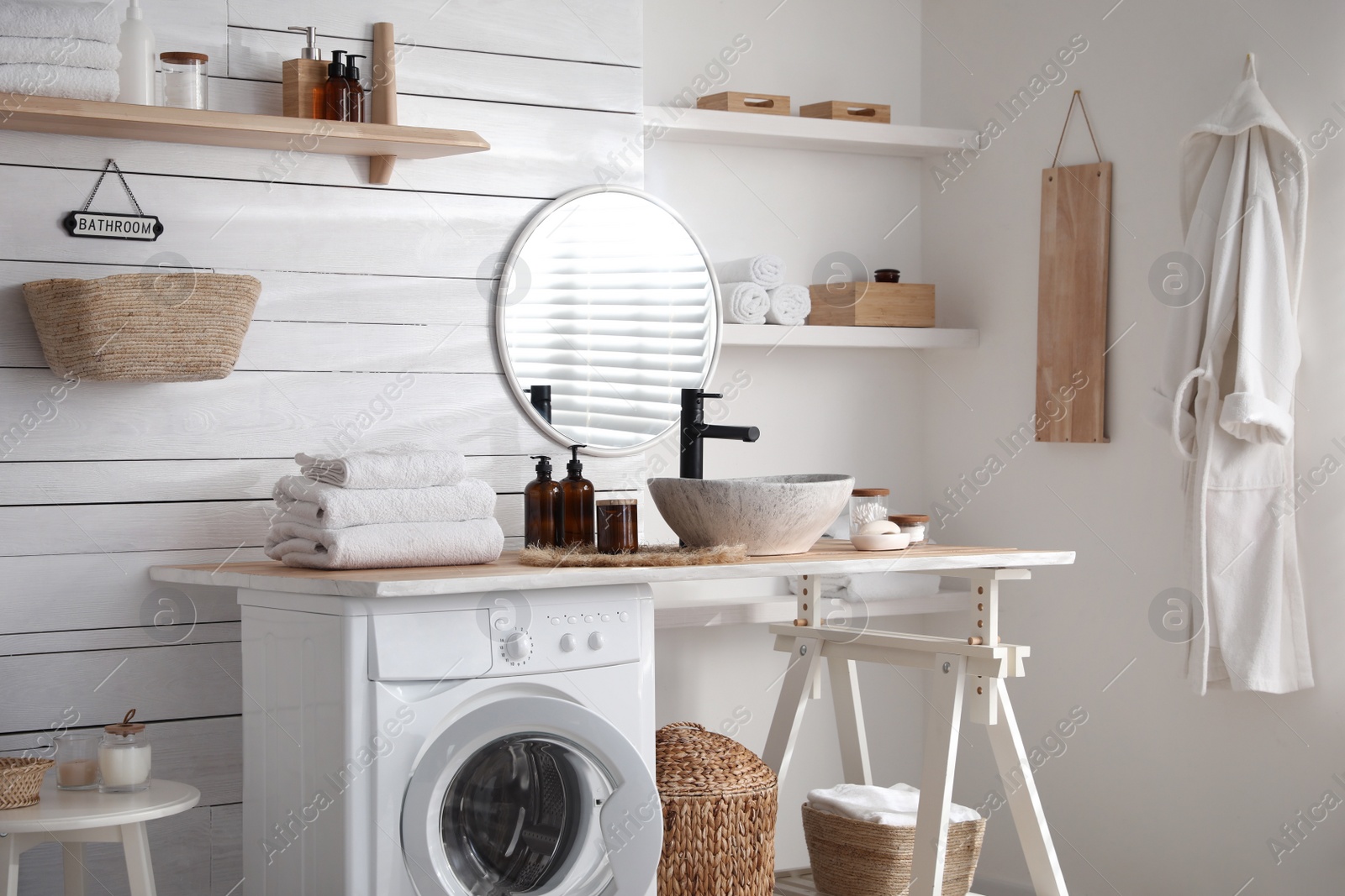 Photo of Stylish bathroom interior with modern washing machine