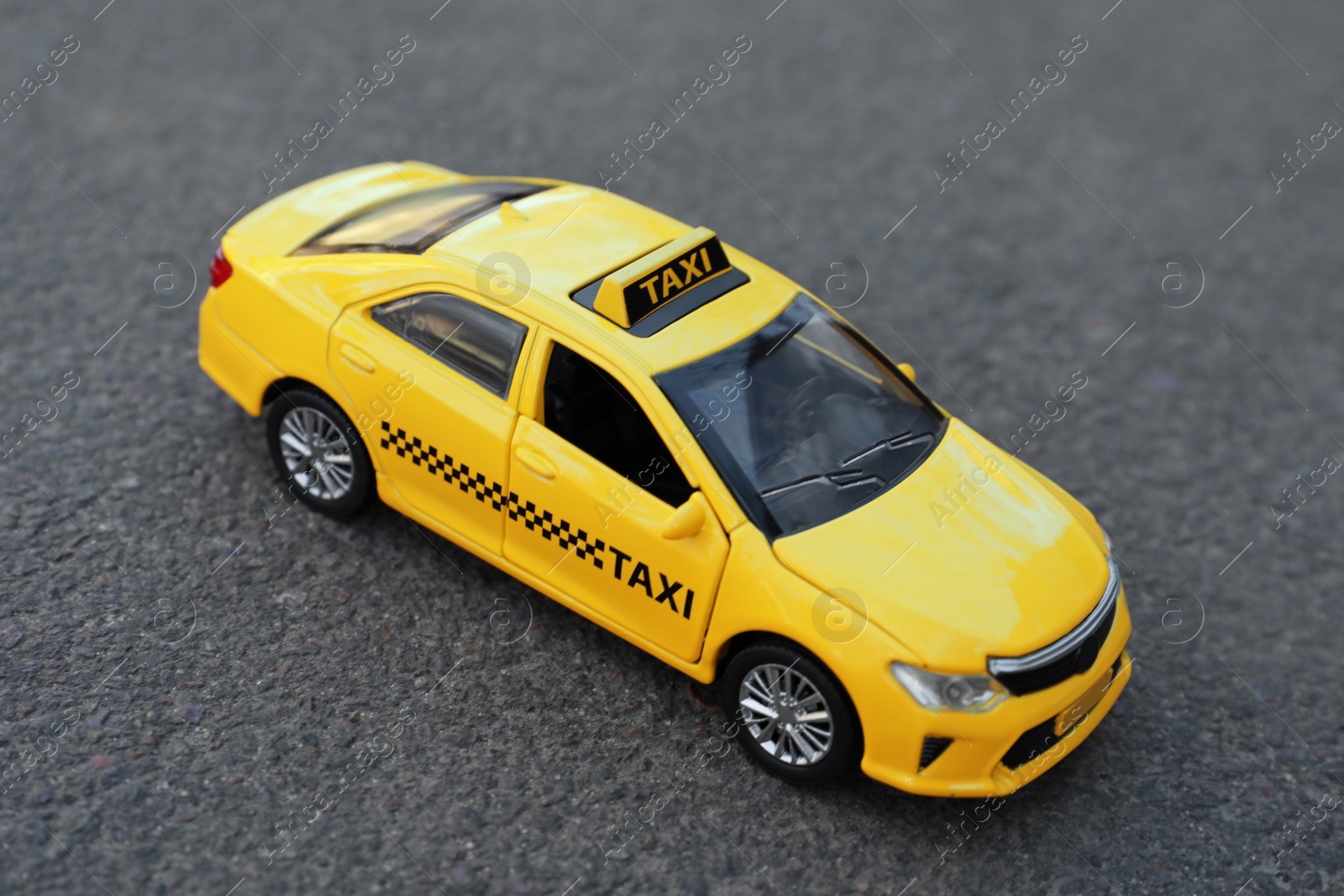 Photo of Yellow taxi car model on city street