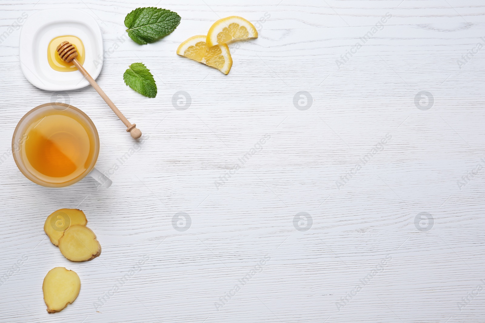 Photo of Composition with cup of lemon tea and ginger on wooden background, top view. Space for text