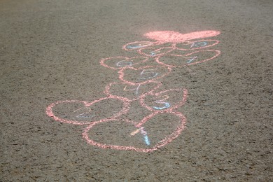 Hopscotch drawn with colorful chalk on asphalt outdoors, closeup