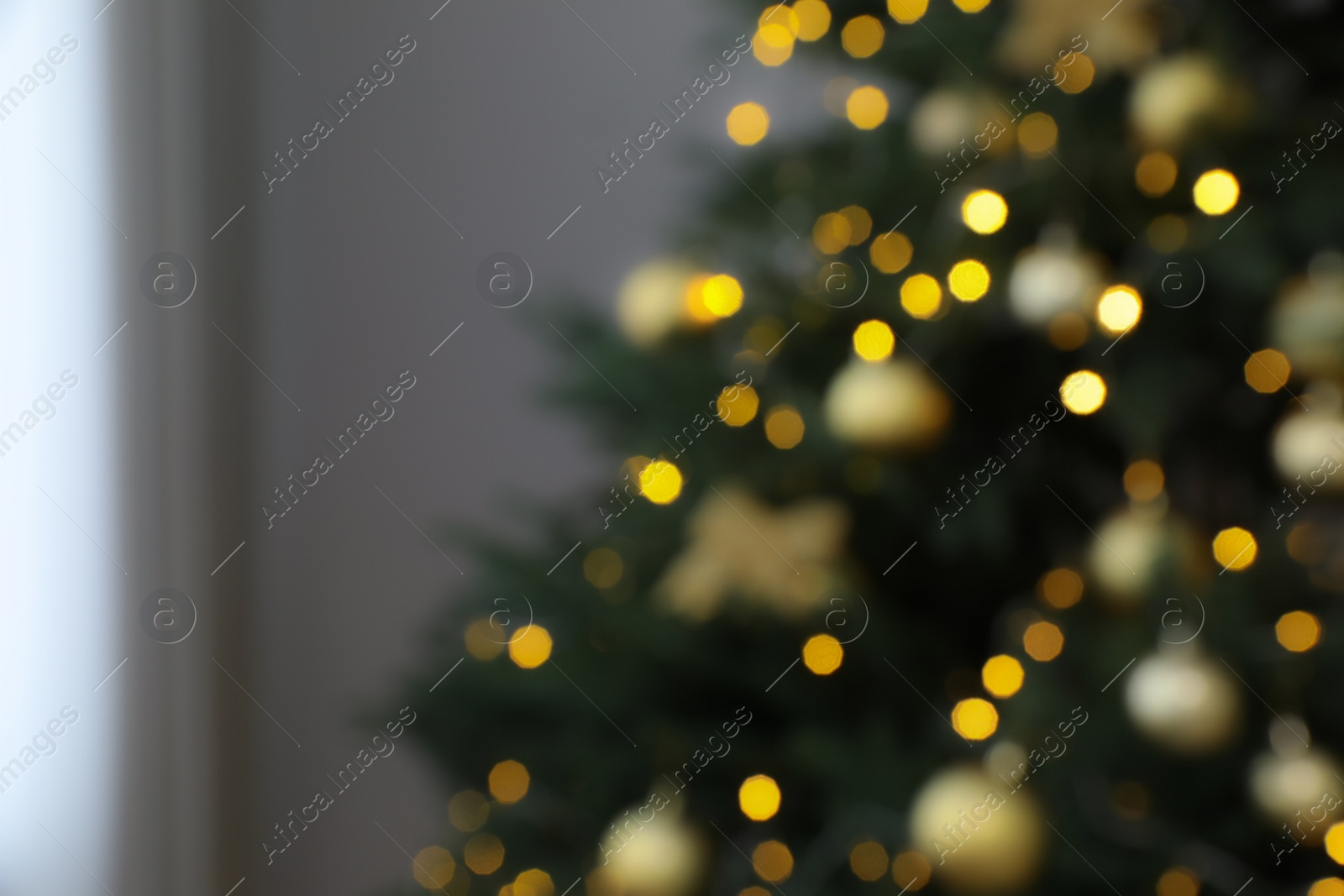 Photo of Blurred view of beautifully decorated Christmas tree indoors