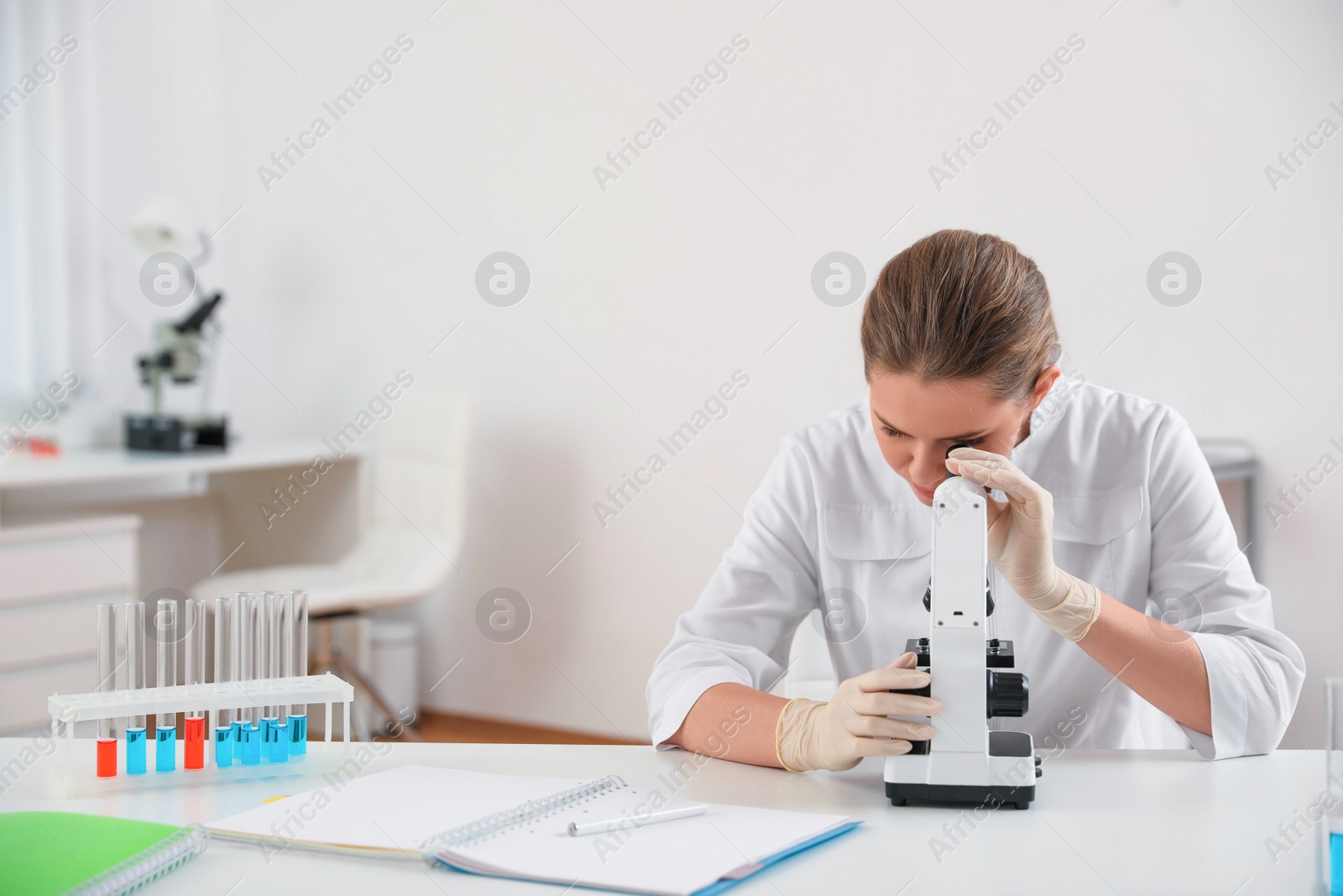 Photo of Scientist using modern microscope at table. Medical research