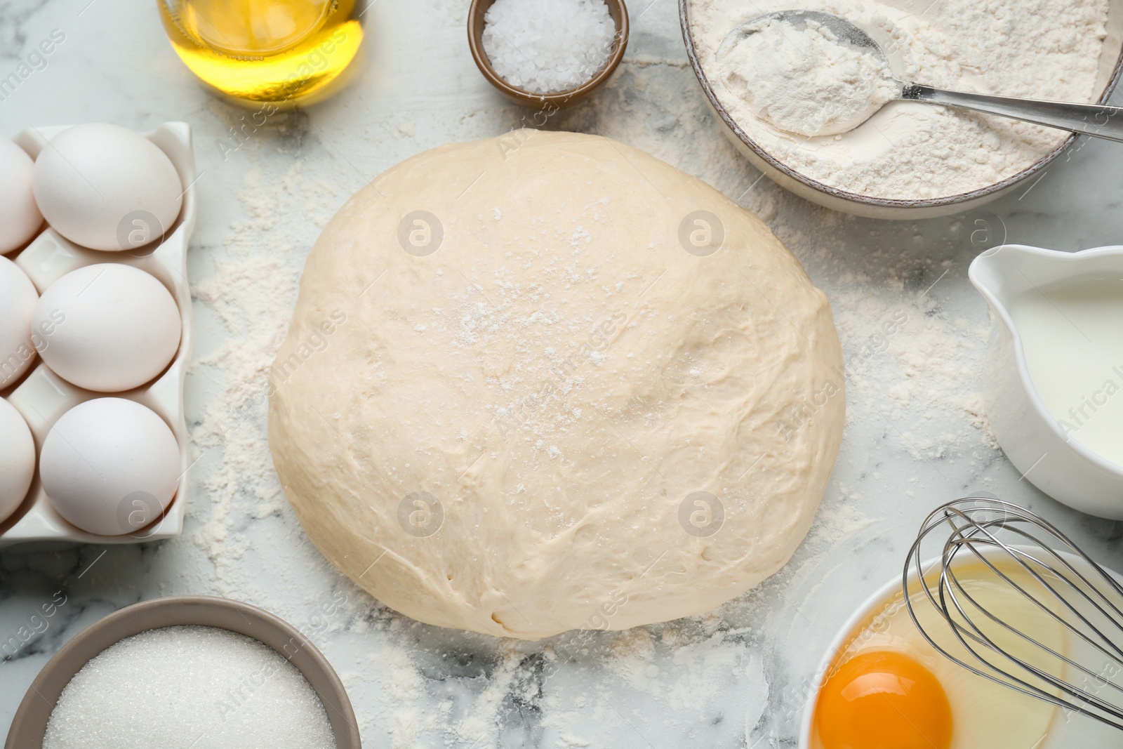 Photo of Fresh yeast dough and ingredients on white marble table, flat lay