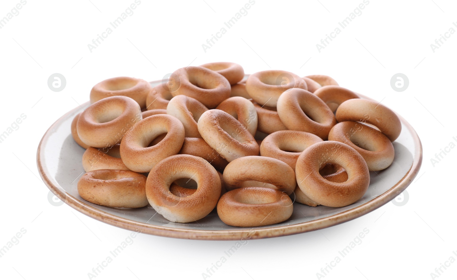 Photo of Plate with tasty dry bagels (sushki) isolated on white