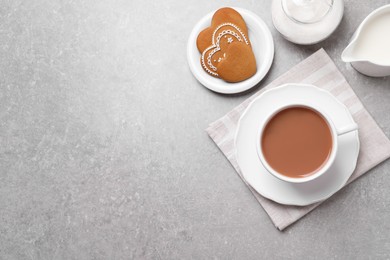 Photo of Delicious tea with milk and cookies on grey table, flat lay. Space for text