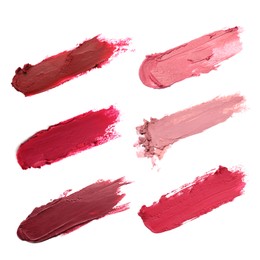 Image of Smears of different beautiful lipsticks on white background, top view