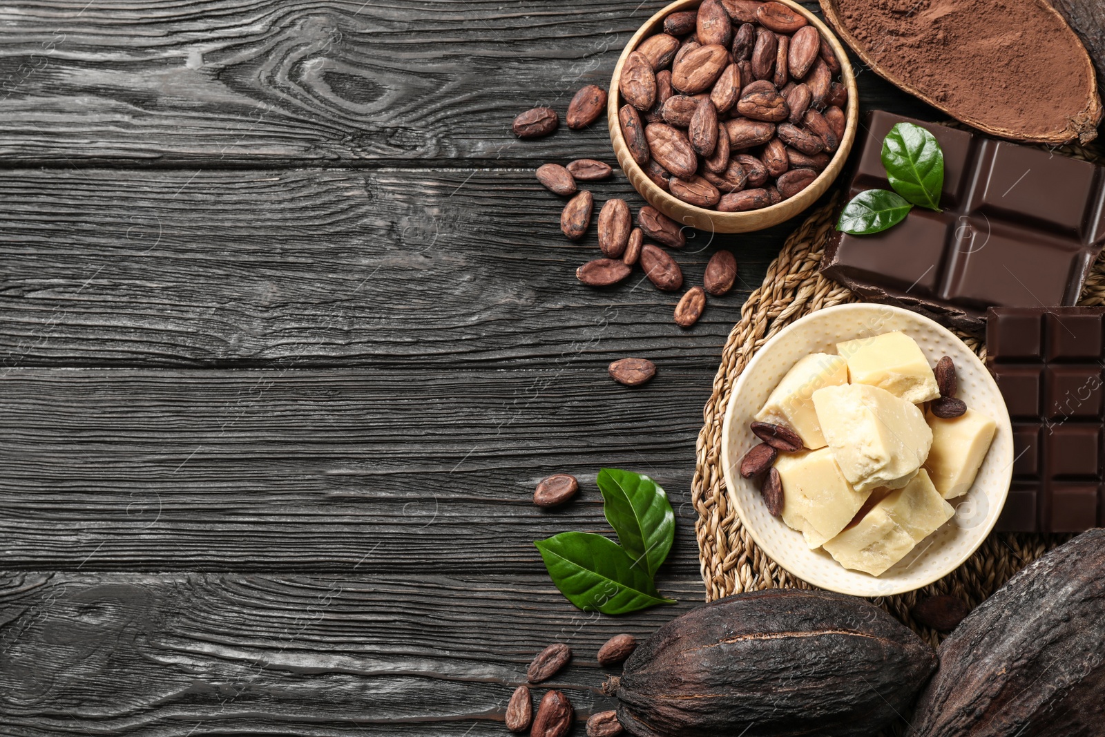 Photo of Flat lay composition with organic cocoa butter on black wooden table. Space for text