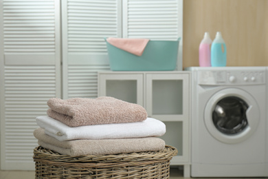 Fresh towels on wicker basket in laundry room