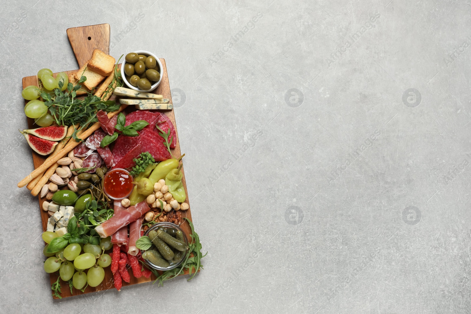 Photo of Set of different delicious appetizers served on light grey table, top view. Space for text