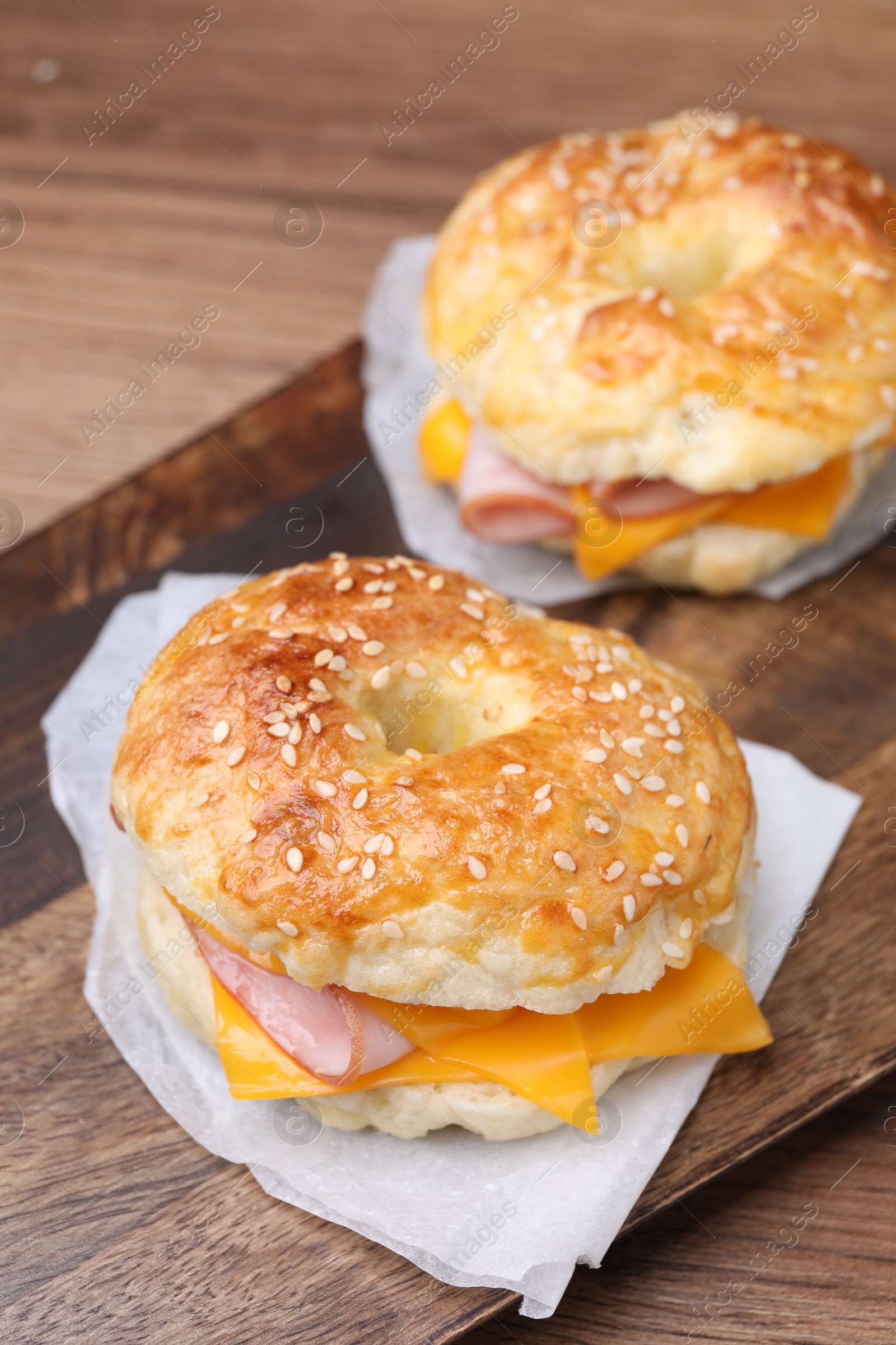 Delicious bagels with ham and cheese on table, closeup Photo of Delicious bagels with ham and cheese on table, closeup
