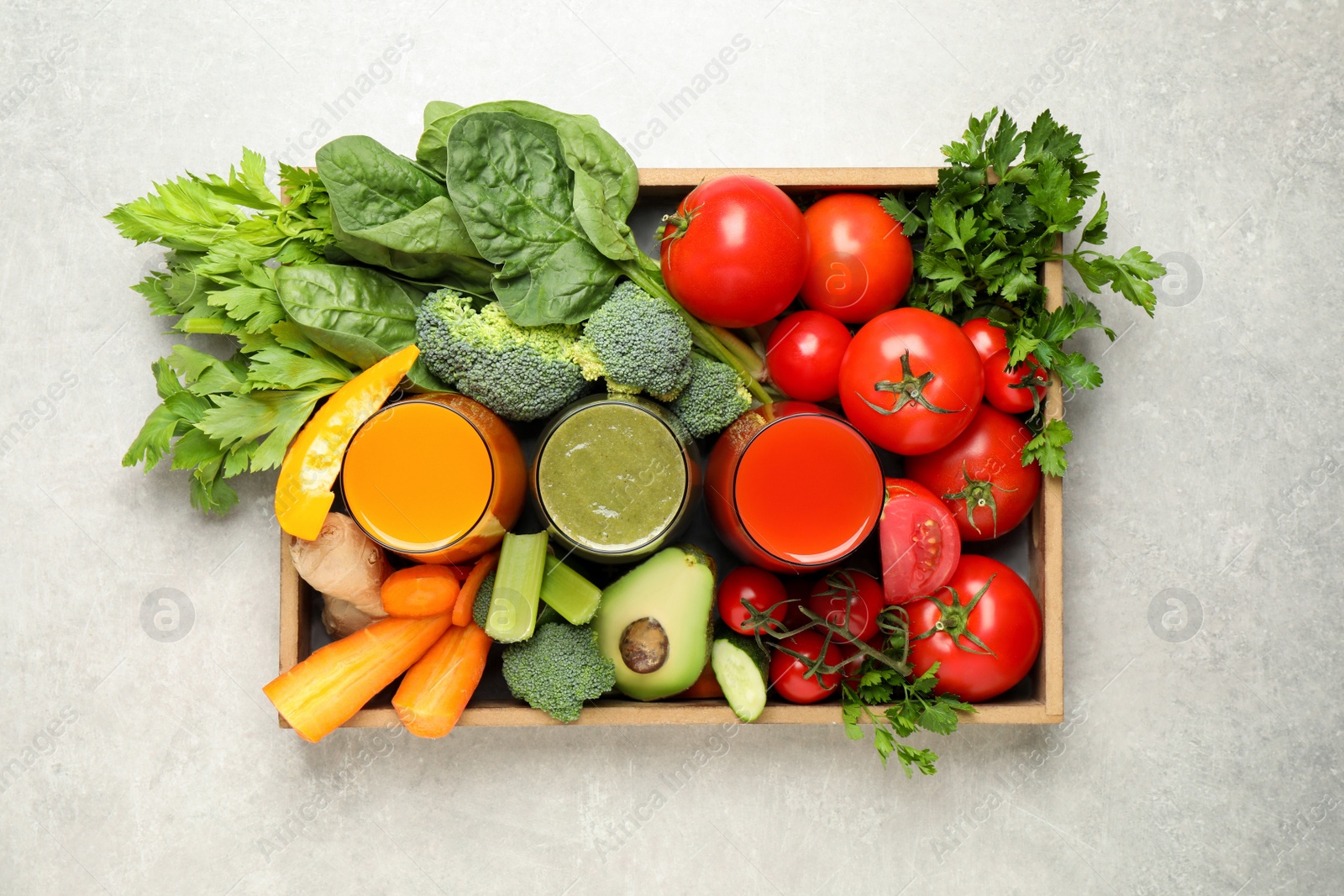 Photo of Delicious vegetable juices and fresh ingredients on light grey table, top view