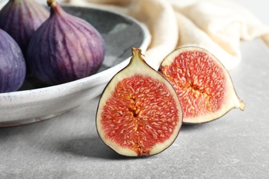 Photo of Fresh ripe figs on gray background, closeup