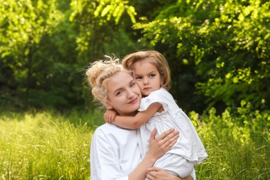 Photo of Portrait of beautiful mother with her cute daughter outdoors