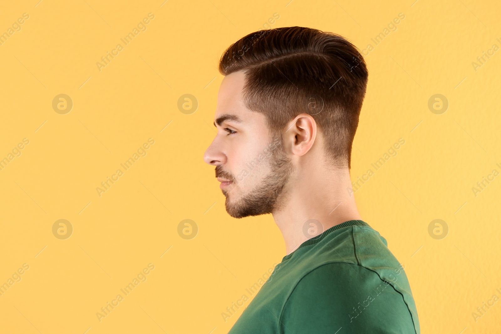 Photo of Portrait of young man with beautiful hair on color background