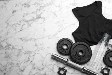 Photo of Flat lay composition with sportswear and equipment on white marble table, space for text. Gym workout